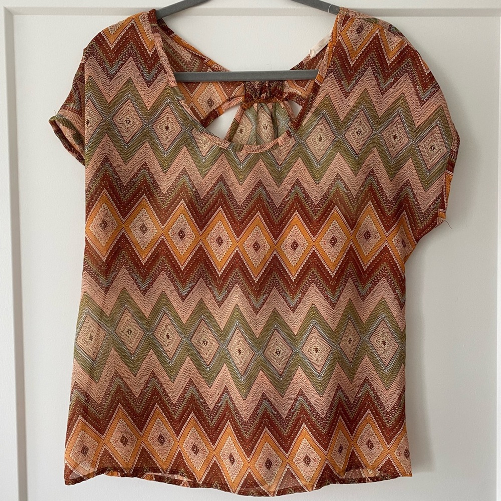 Earth-tone sheer top with cut outs and fun pattern